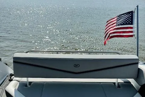Slide: The Image of 2022 Cobalt R6 Surf boat with American flag on water. - 18