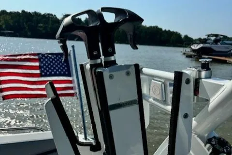 Slide: The Image of 2022 Cobalt R6 Surf boat with American flag on a lake. - 19