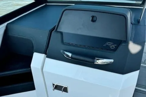 Slide: The Image of 2022 Cobalt R6 Surf boat dashboard with storage compartment. - 21