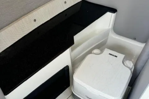 Slide: The Image of 2022 Cobalt R6 Surf boat interior with compact marine toilet. - 22