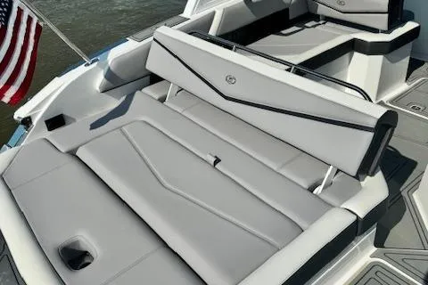 Slide: The Image of 2022 Cobalt R6 Surf boat with luxurious seating and American flag. - 29