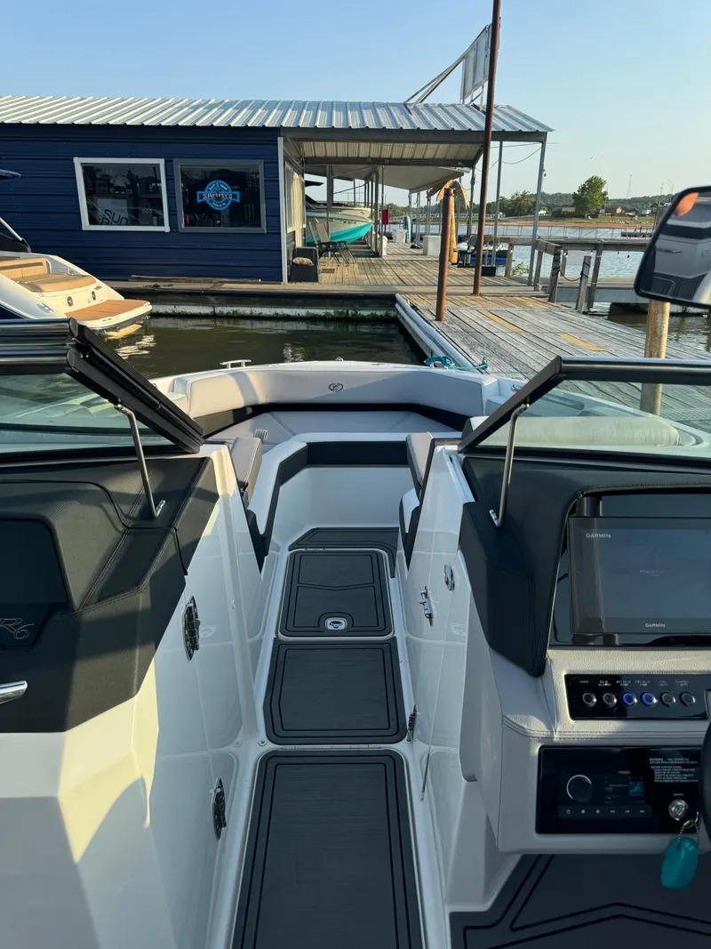 Slide: The Image of 2022 Cobalt R6 Surf boat interior at a marina dock. - 31