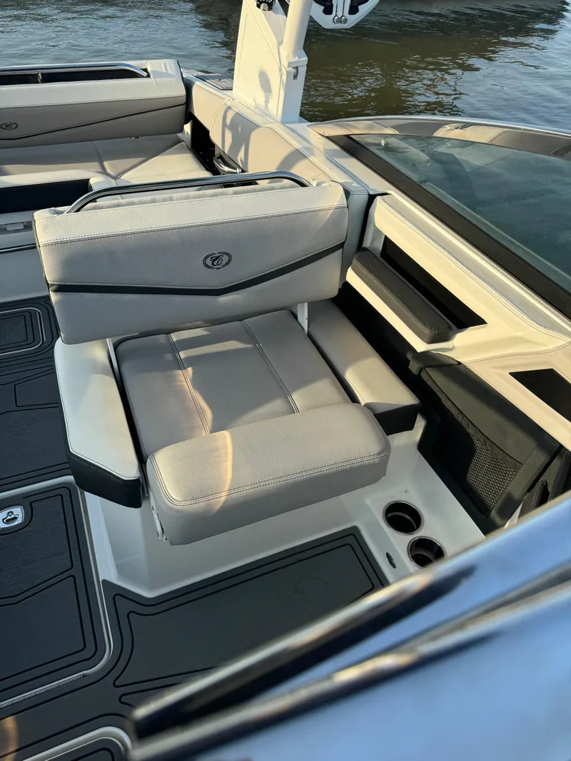 Slide: The Image of 2022 Cobalt R6 Surf boat interior with cushioned seating and cup holders. - 33
