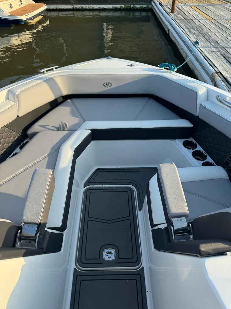 Slide: The Image of 2022 Cobalt R6 Surf boat interior with gray seating and storage compartments. - 34
