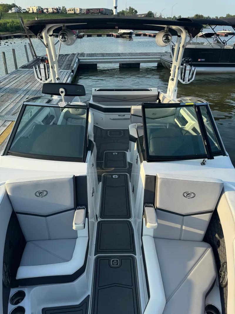 Slide: The Image of 2022 Cobalt R6 Surf boat docked at a marina, featuring sleek seating and modern design. - 35