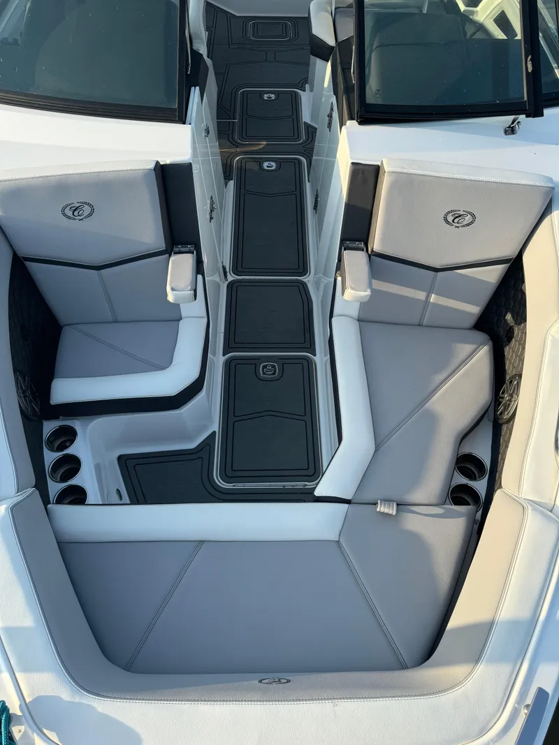 Slide: The Image of 2022 Cobalt R6 Surf boat interior with gray seating and cup holders. - 37