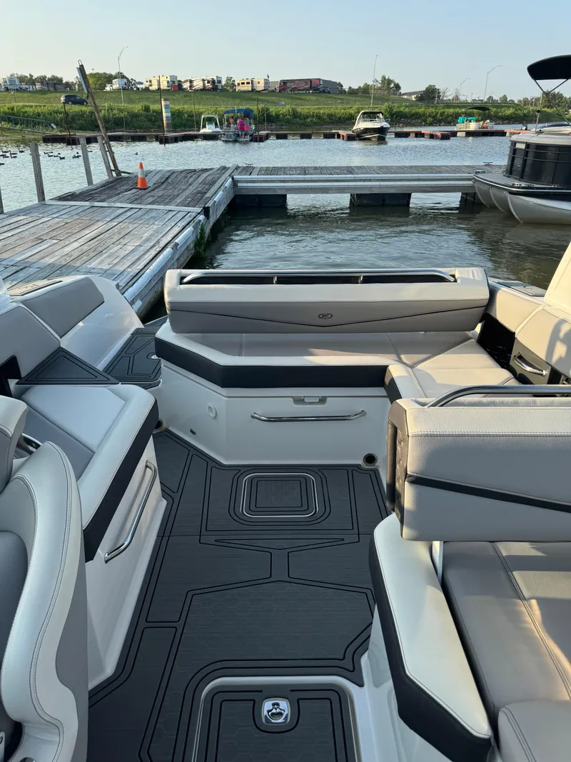 Slide: The Image of 2022 Cobalt R6 Surf boat interior with sleek seating and modern design at a dock. - 40