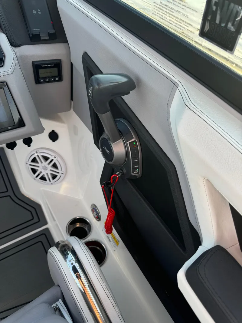 Slide: The Image of 2022 Cobalt R6 Surf boat interior with throttle control and speaker. - 42