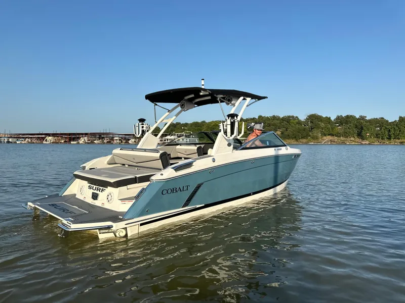 Slide: The Image of 2022 Cobalt R6 Surf boat on calm water, clear sky background. - 5