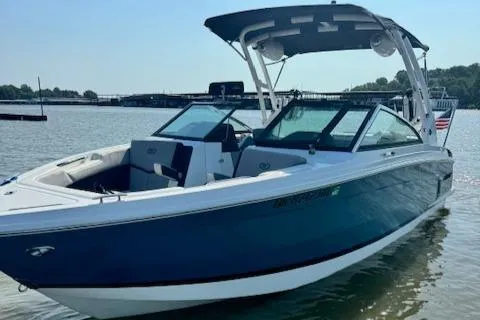 Slide: The Image of 2022 Cobalt R6 Surf boat on calm water with a clear sky background. - 7