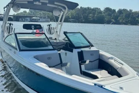 Slide: The Image of 2022 Cobalt R6 Surf boat on a lake with scenic background. - 9