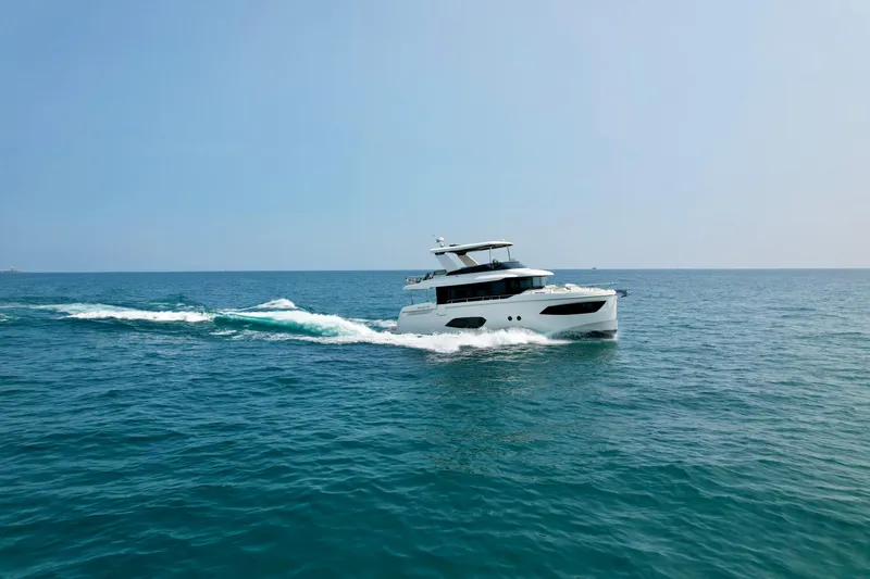 The Image of 2023 Absolute 52 Navetta yacht cruising on open sea under clear sky. - 0