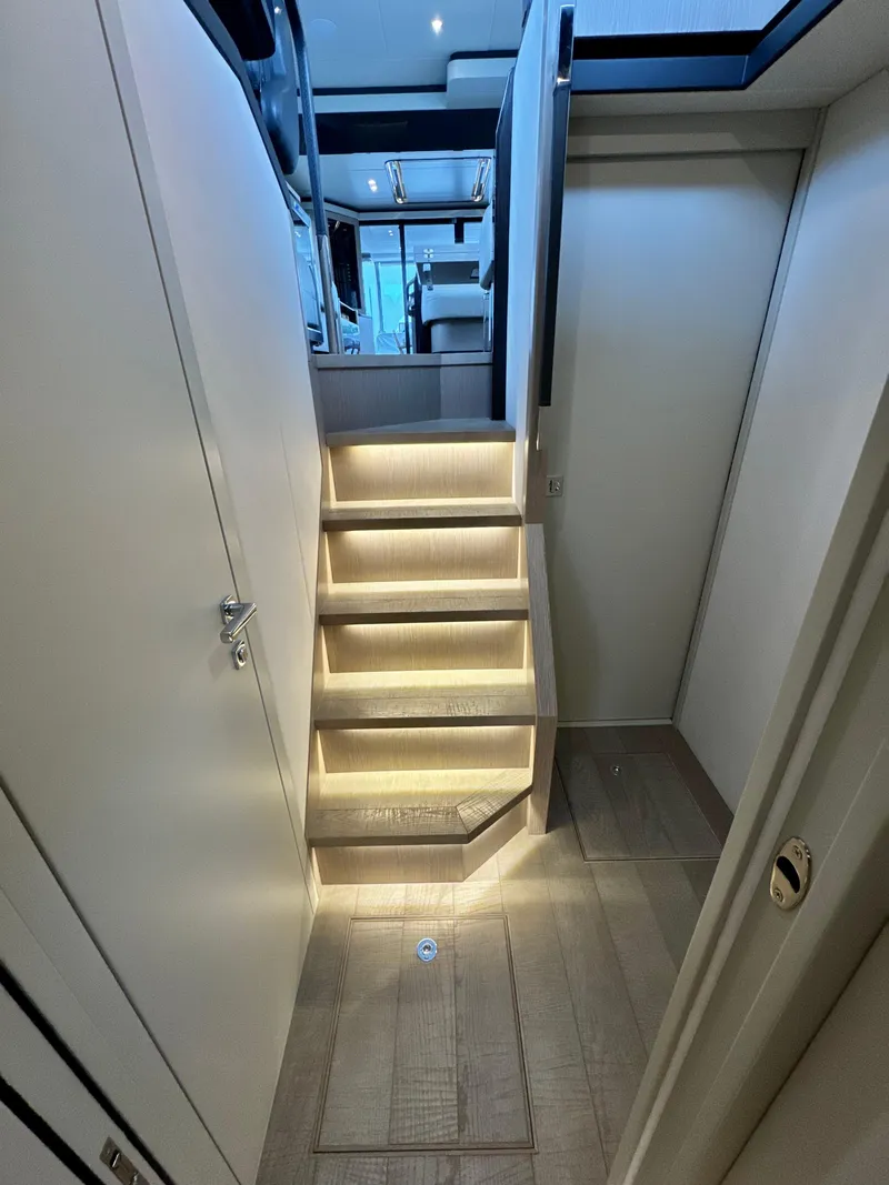 Slide: The Image of Interior staircase of 2023 Absolute 52 Navetta yacht, featuring modern lighting and sleek design. - 13