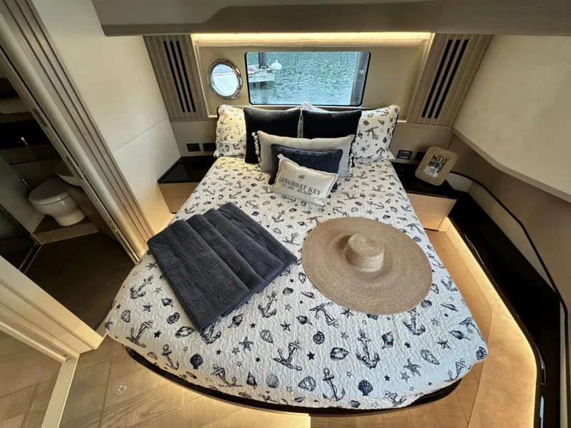 Slide: The Image of Luxurious bedroom interior of 2023 Absolute 52 Navetta yacht with nautical-themed decor. - 23