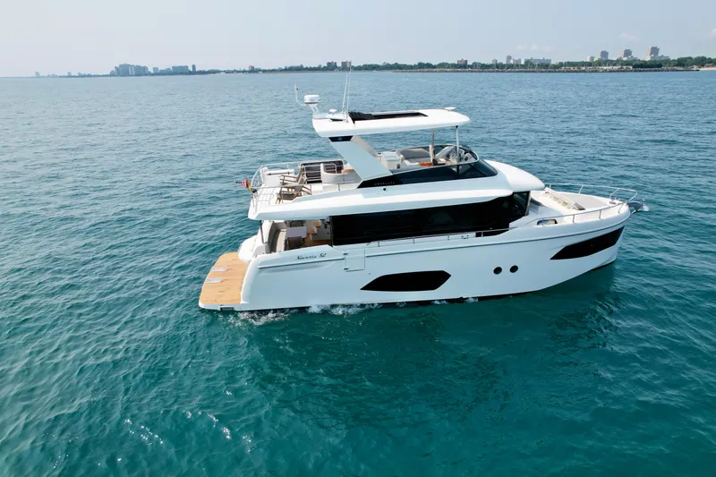Slide: The Image of Luxury 2023 Absolute 52 Navetta yacht cruising on open water. - 3