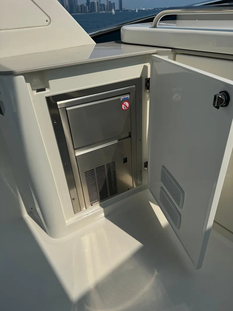 Slide: The Image of 2023 Absolute 52 Navetta yacht with open cabinet and built-in appliance. - 32