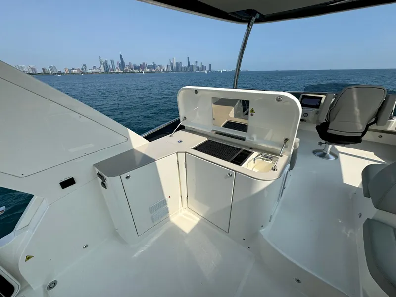 Slide: The Image of Luxury yacht Absolute 52 Navetta 2023 with city skyline view, featuring outdoor kitchen. - 34