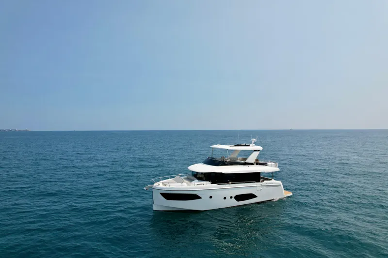 Slide: The Image of 2023 Absolute 52 Navetta yacht cruising on open sea under clear sky. - 41