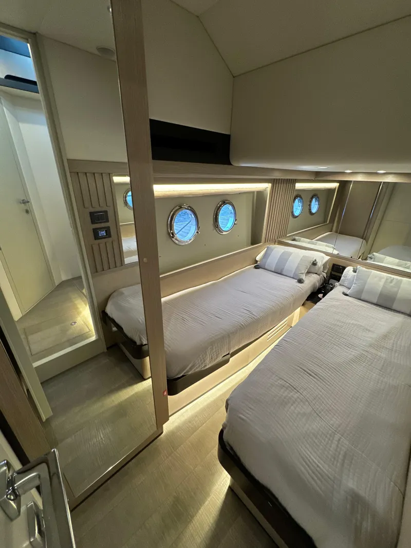 Slide: The Image of Luxurious cabin interior of 2023 Absolute 52 Navetta yacht with twin beds and portholes. - 26