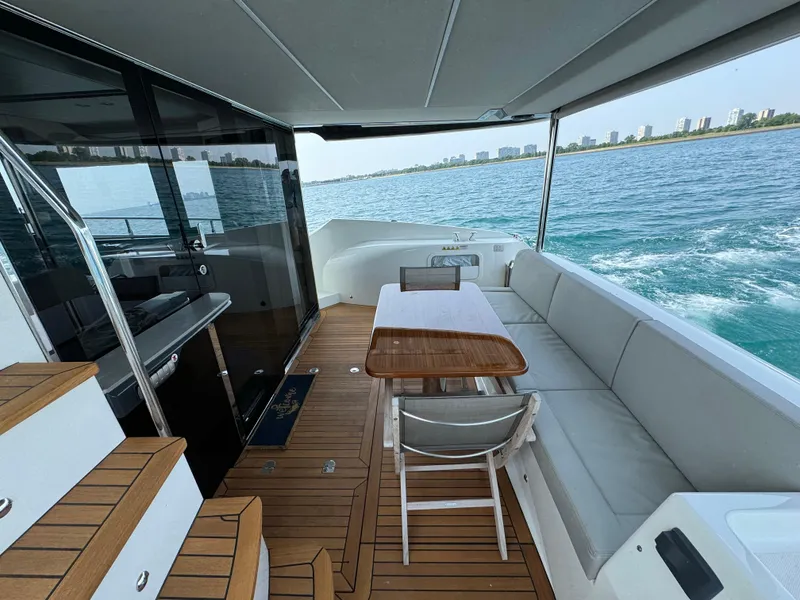 Slide: The Image of Luxurious 2023 Absolute 52 Navetta yacht deck with seating and ocean view. - 28