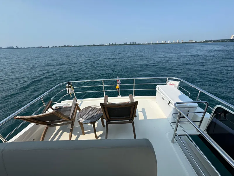 Slide: The Image of Deck view of 2023 Absolute 52 Navetta yacht overlooking calm ocean waters. - 31