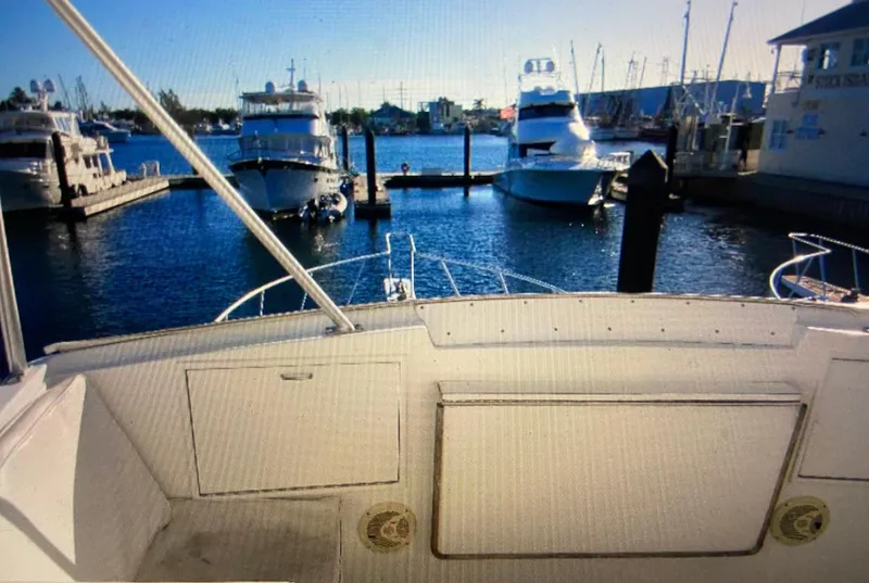 Slide: The Image of 1988 Ocean Yachts 55 Super Sport docked in a sunny marina. - 10