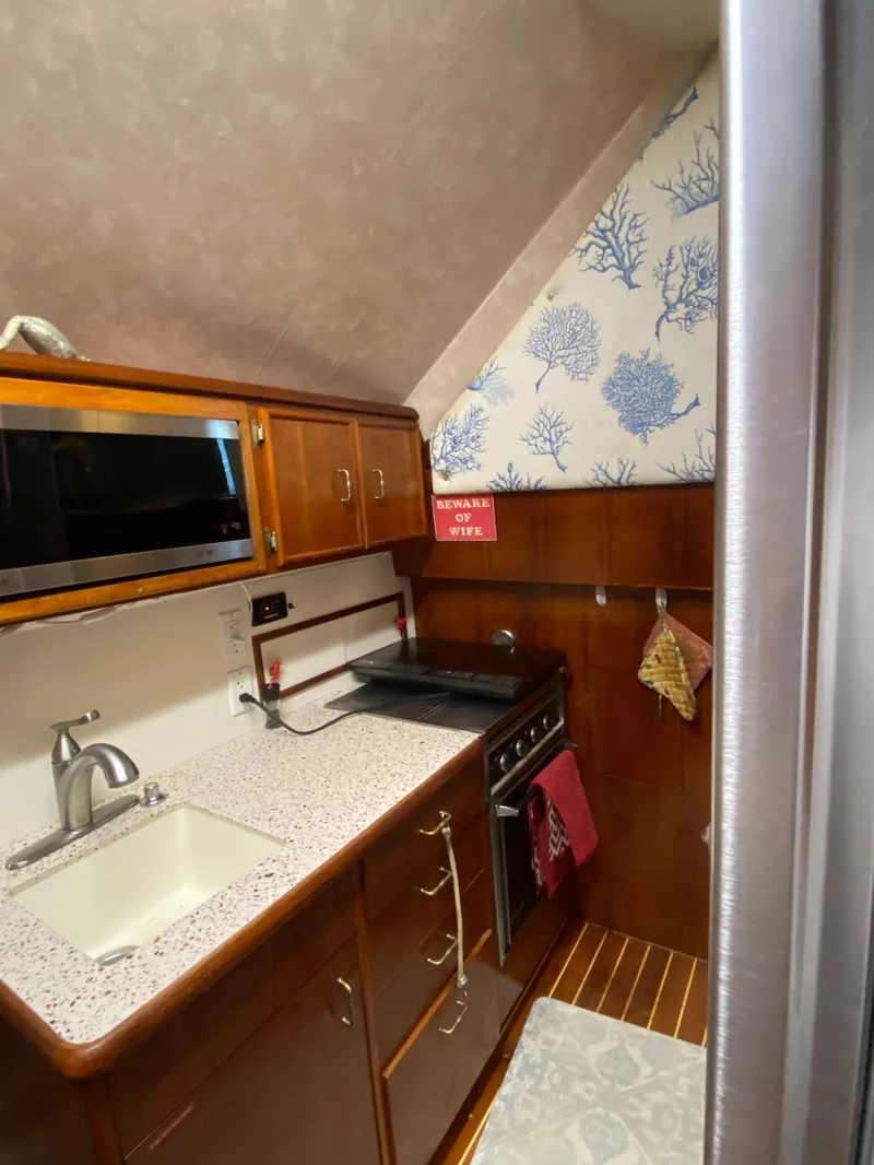 Slide: The Image of 1988 Ocean Yachts 55 Super Sport kitchen with wood cabinetry and modern appliances. - 14