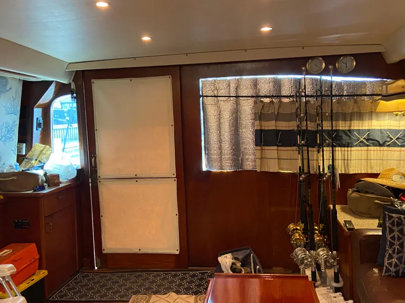 Slide: The Image of Interior of 1988 Ocean Yachts 55 Super Sport with fishing gear and cozy decor. - 16