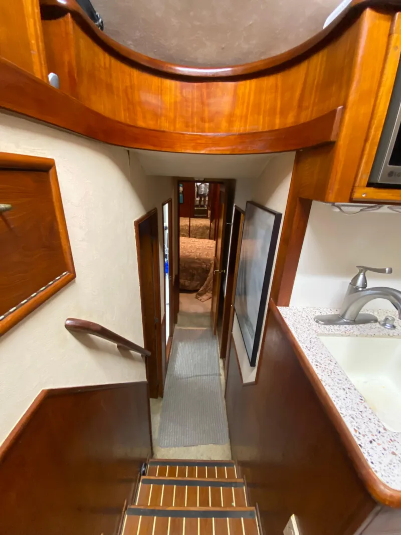 Slide: The Image of Interior view of 1988 Ocean Yachts 55 Super Sport, featuring wooden stairs and modern amenities. - 18