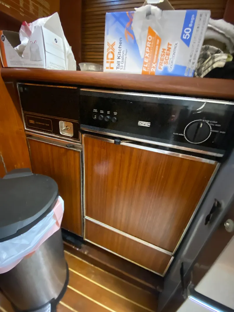 Slide: The Image of 1988 Ocean Yachts 55 Super Sport kitchen with vintage wood paneling and appliances. - 22