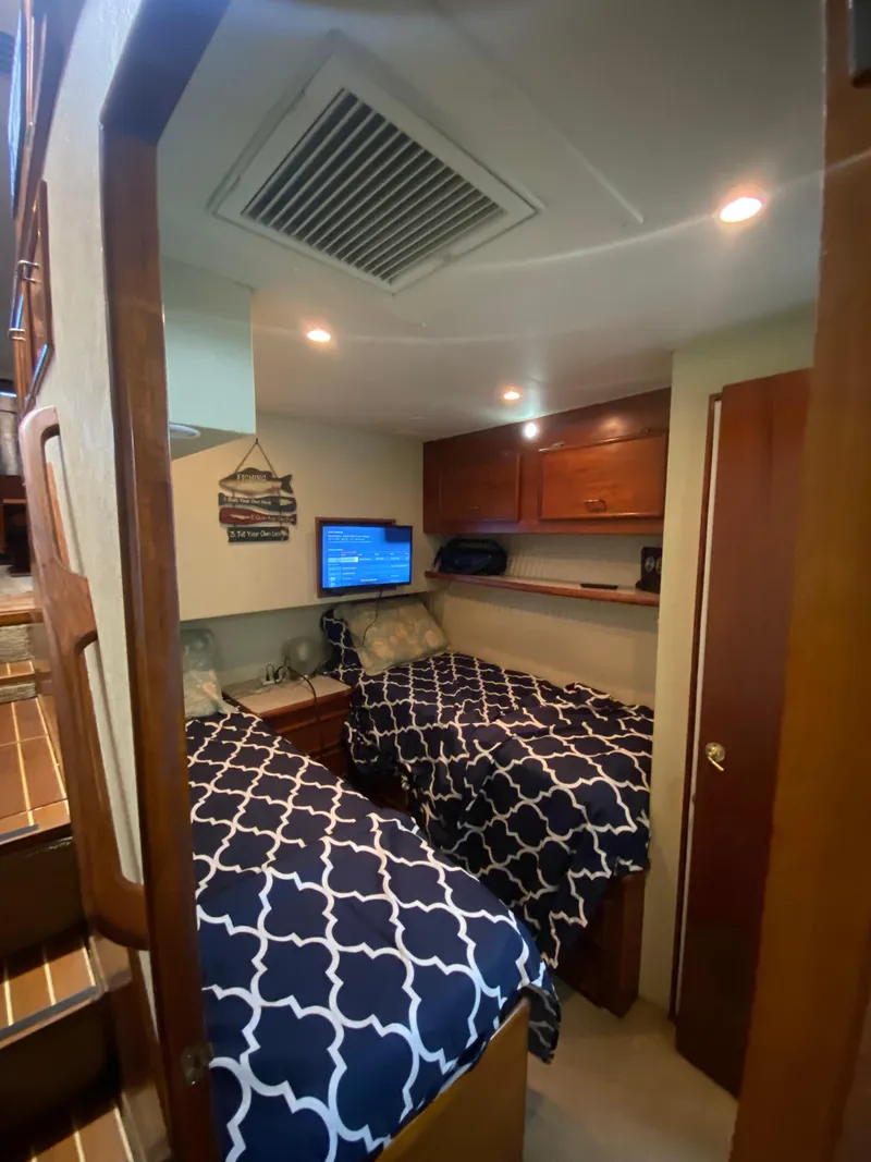 Slide: The Image of Cozy cabin interior of 1988 Ocean Yachts 55 Super Sport with twin beds and wood accents. - 23