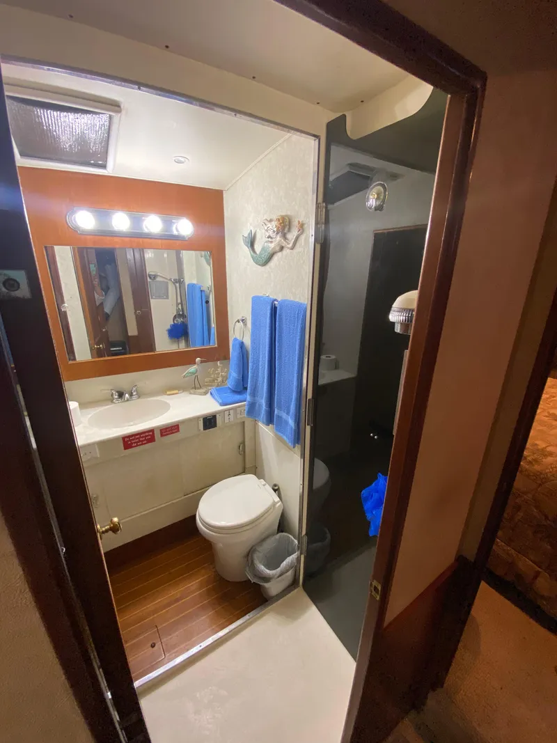 Slide: The Image of 1988 Ocean Yachts 55 Super Sport bathroom with sink, mirror, and shower. - 26
