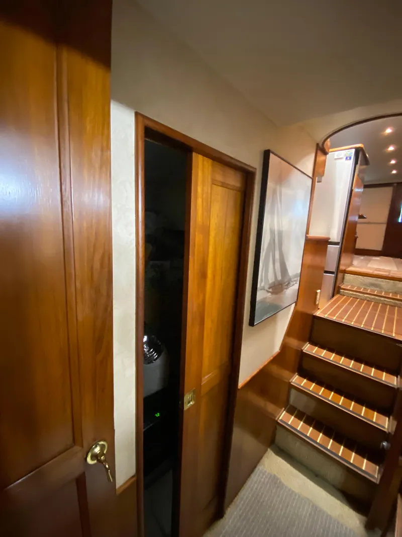 Slide: The Image of Interior of 1988 Ocean Yachts 55 Super Sport with wooden finishes and staircase. - 27