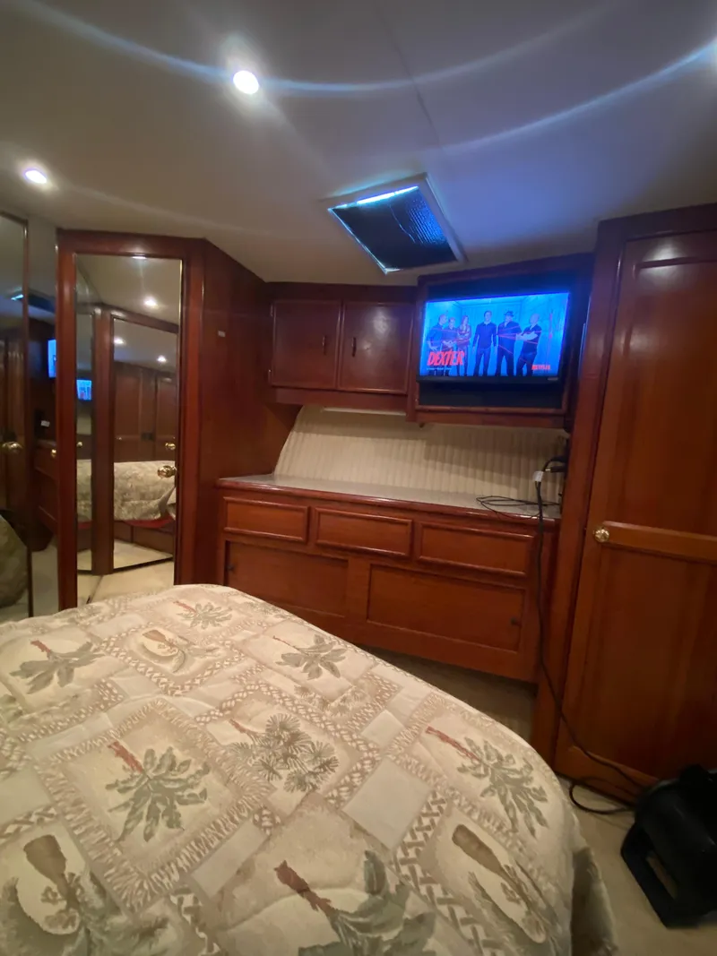 Slide: The Image of Luxurious cabin interior of 1988 Ocean Yachts 55 Super Sport with wood paneling and TV. - 28