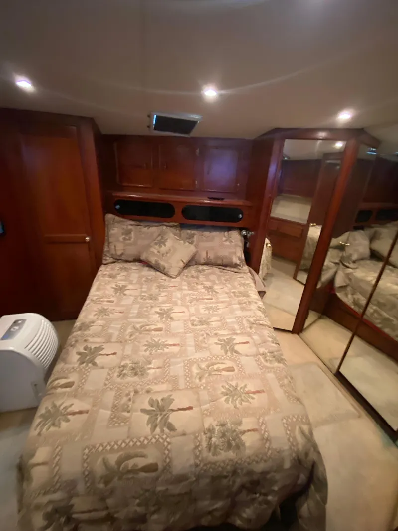 Slide: The Image of Luxurious bedroom in 1988 Ocean Yachts 55 Super Sport with elegant wood finishes. - 29