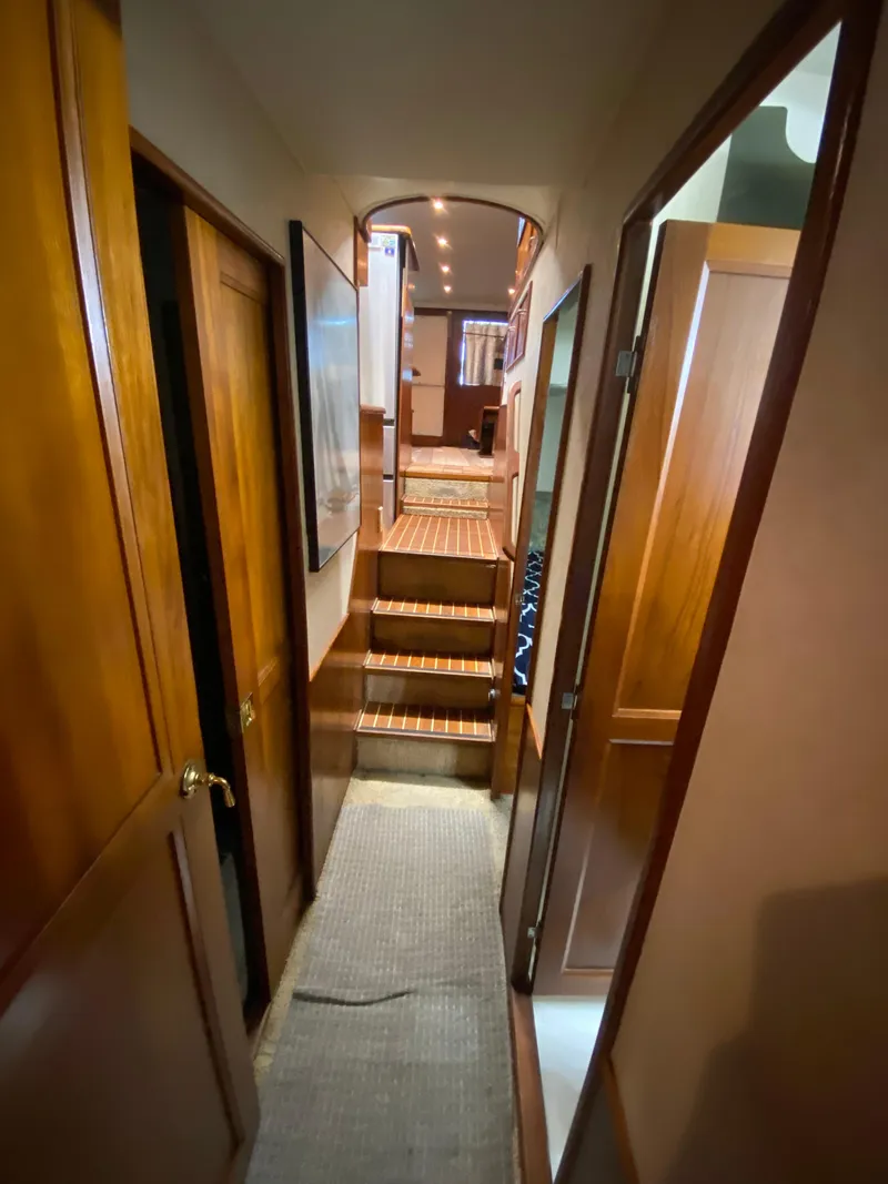 Slide: The Image of Interior hallway of 1988 Ocean Yachts 55 Super Sport with wooden finishes. - 31