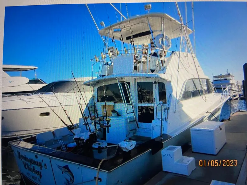 Slide: The Image of 1988 Ocean Yachts 55 Super Sport docked, equipped for fishing, with clear blue sky. - 4