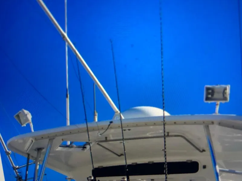 Slide: The Image of Ocean Yachts 55 Super Sport 1988 boat deck with antennas against clear blue sky. - 7