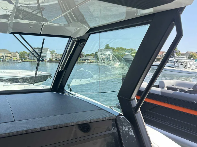 Slide: The Image of 2025 Formula 387 Center Console Fish boat with foldable white and blue seating. - 17