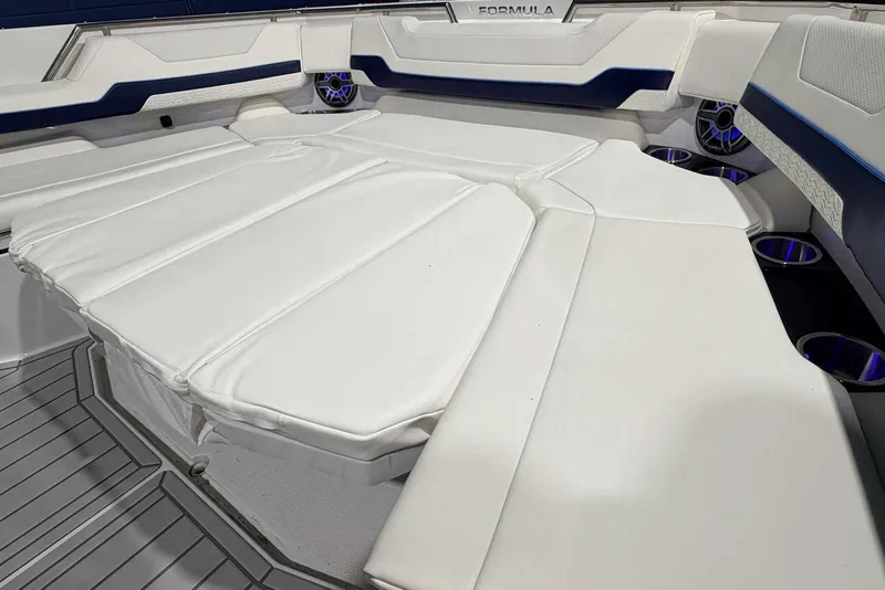 Slide: The Image of 2025 Formula 387 Center Console Fish boat interior with white cushioned seating. - 64