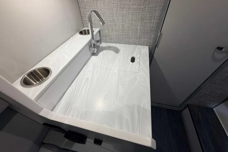 Slide: The Image of 2025 Formula 387 Center Console Fish boat interior with sleek sink and modern faucet design. - 82