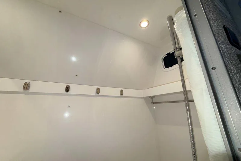 Slide: The Image of Interior of 2025 Formula 387 Center Console Fish boat, featuring sleek white walls and lighting. - 91