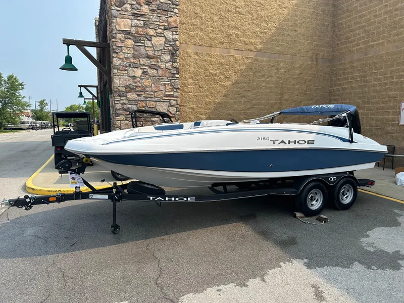 The Image of 2024 Tahoe 2150 boat on trailer, parked outdoors. - 0
