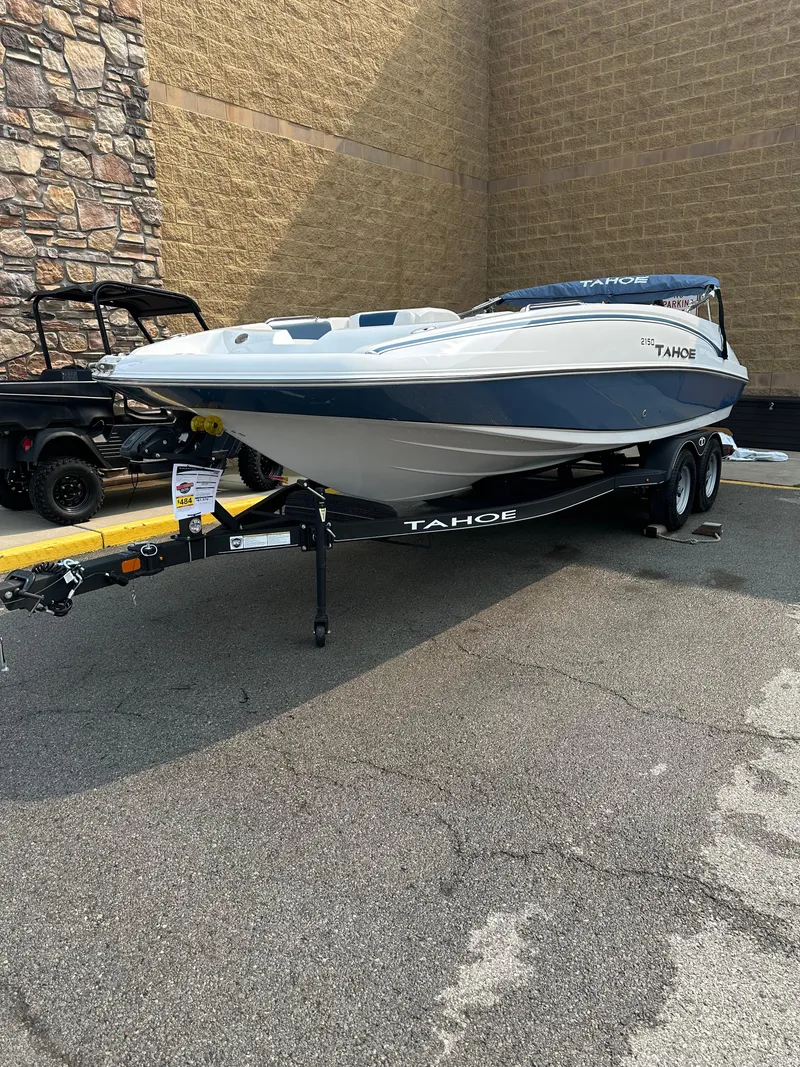 Slide: The Image of 2024 Tahoe 2150 boat on trailer in outdoor setting. - 2