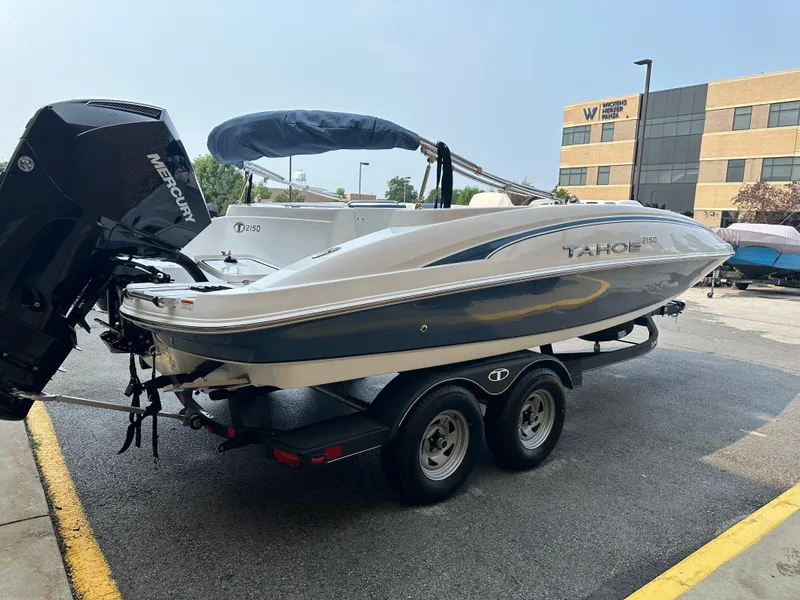 Slide: The Image of 2024 Tahoe 2150 boat on a trailer with a Mercury outboard motor. - 3
