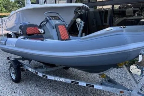 Slide: The Image of 2023 Highfield Sport 390 inflatable boat on trailer, gray with red accents. - 0