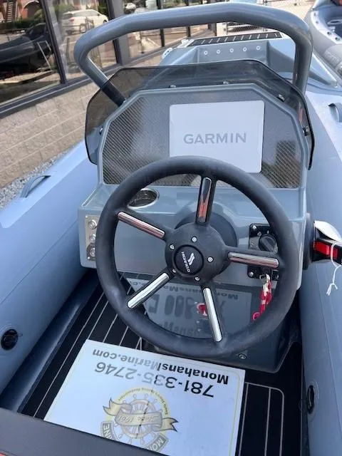 Slide: The Image of 2023 Highfield Sport 390 boat dashboard with Garmin navigation system. - 2