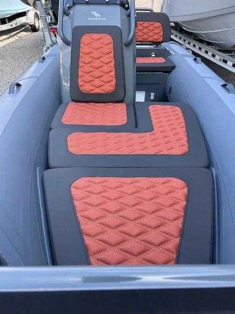 Slide: The Image of 2023 Highfield Sport 390 boat interior with orange quilted seats. - 3