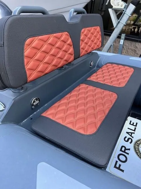 Slide: The Image of 2023 Highfield Sport 390 boat seats with red diamond stitching, for sale sign visible. - 4