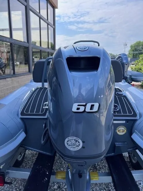 Slide: The Image of 2023 Highfield Sport 390 boat with 60 HP engine, parked outdoors. - 5